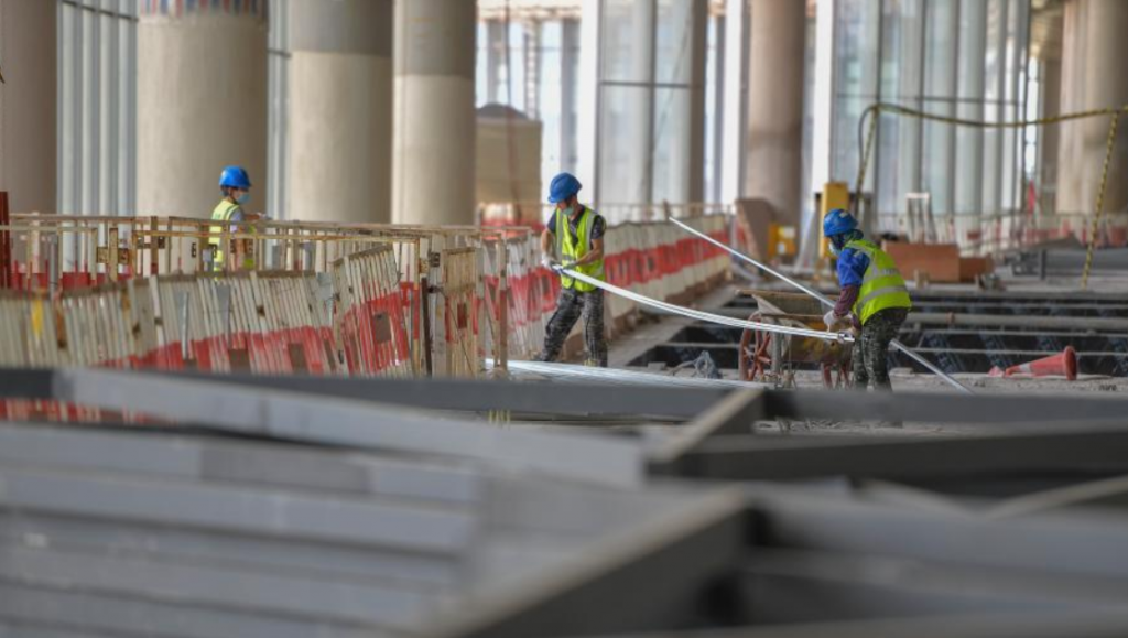 Workers wearing masks at the construction site of Haikou Meilan International Airport