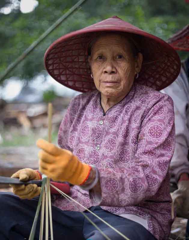 A Li Minority Villager Working on House Building