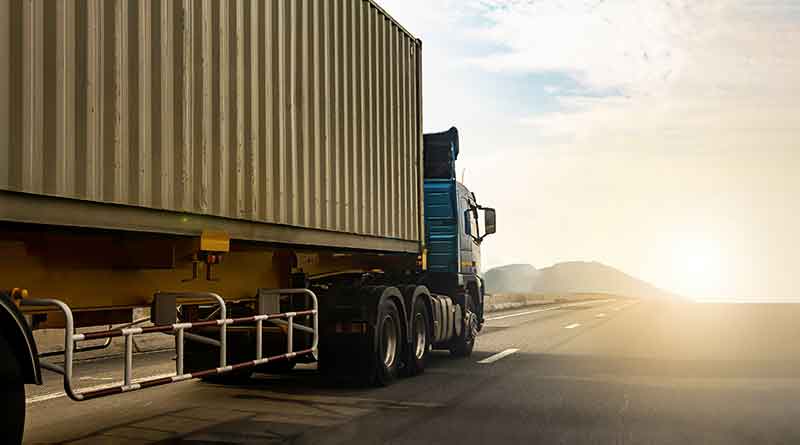 Cargo-truck-on-highway-road-with-container,-transportation-feature-image