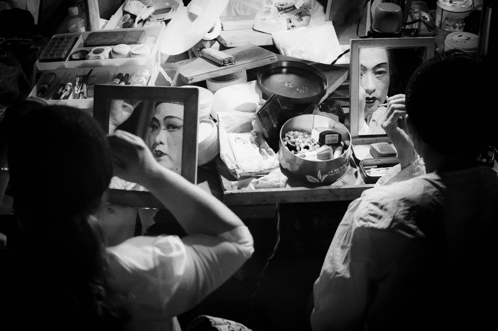 Hainan opera performers putting on their makeup